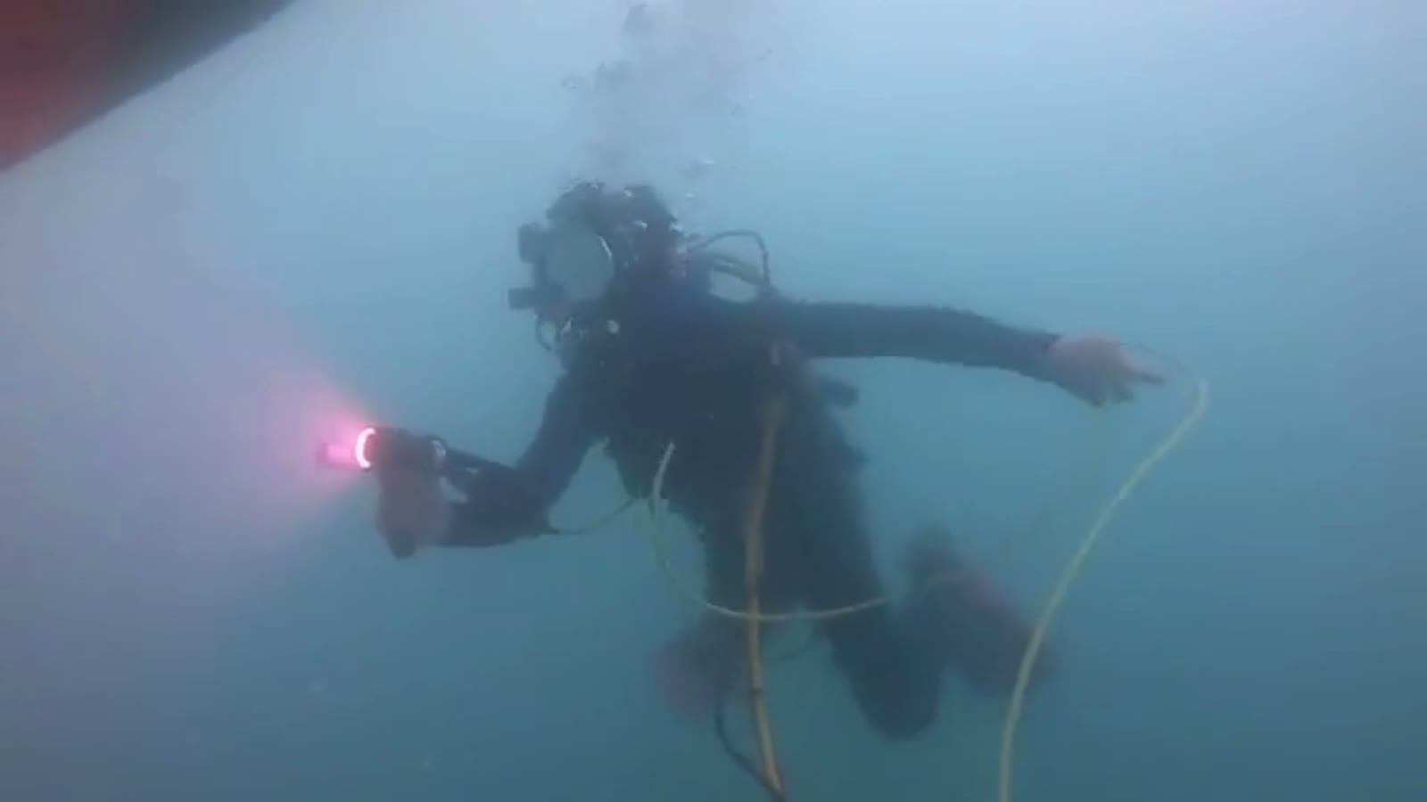 Diver carrying out an in-water class survey on a vessel's hull